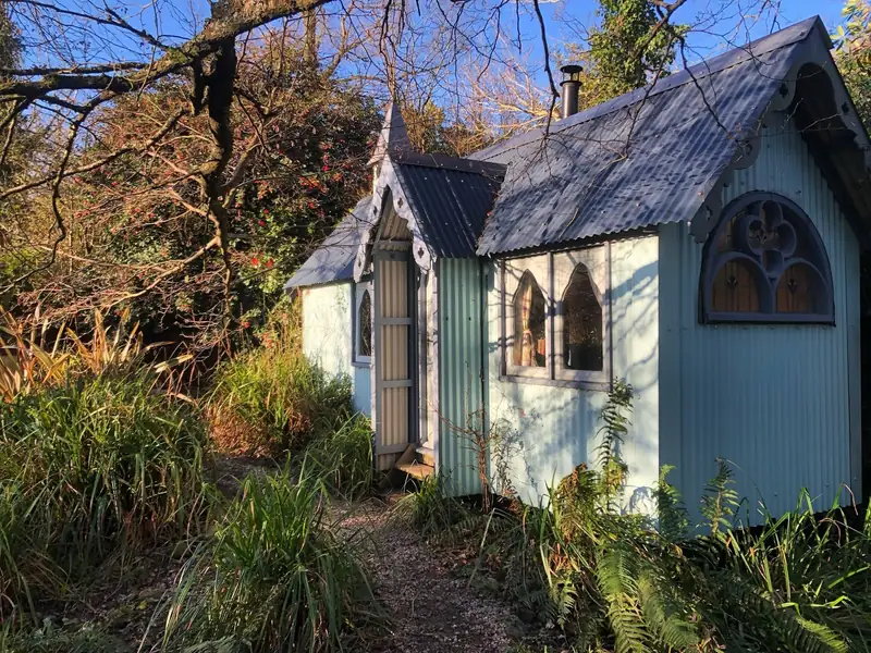 The Tabernacle's pale blue walls and gothic arched windows in low winter sun