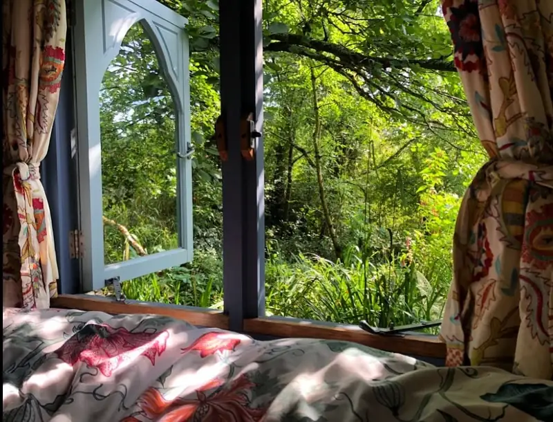 Morning light through the open window beside the bed