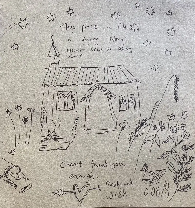 A hand-drawn thank-you note from guests, showing the hut beneath the stars